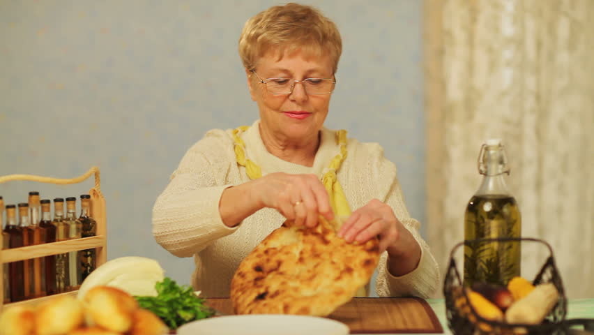 Senior woman making sandwich 