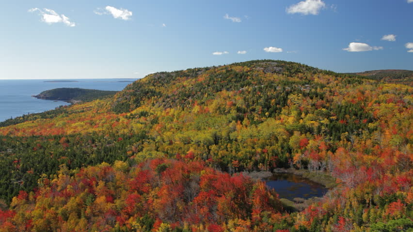 Panning view in Acadia National Park in Autumn from The Beehive. Landmarks include  Otter Point, Gorham Mountain, and Kief Pond.