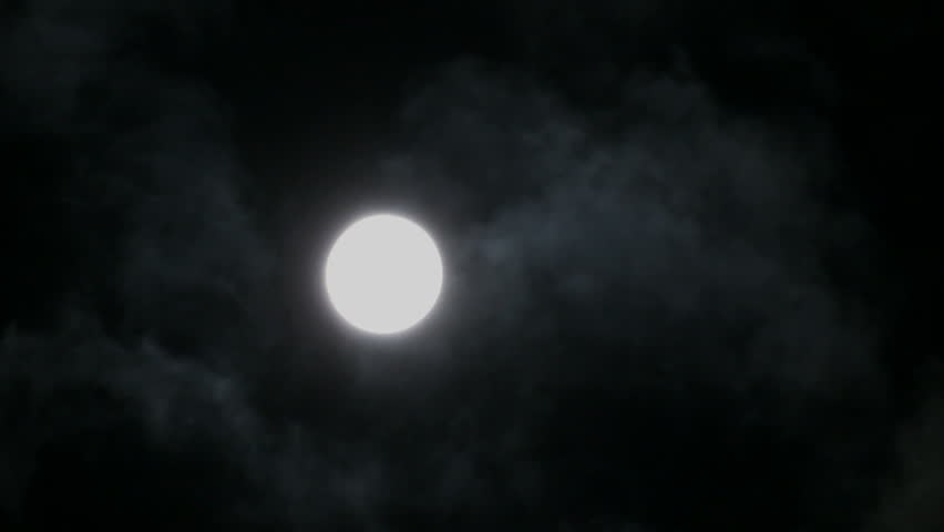timelapse with moon moving between clouds