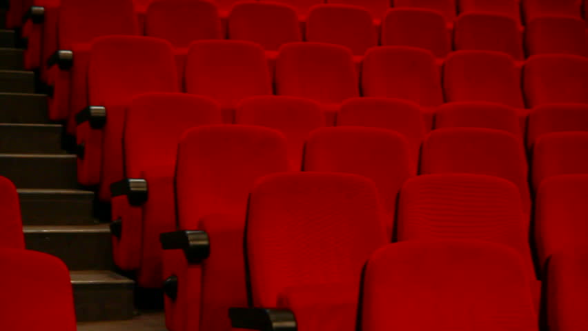 empty auditorium - red chairs in rows