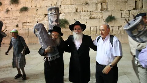 JERUSALEM, ISRAEL - AUGUST 8, 2015: Rabbi dance with 65 Bible Torah scrolls inaugurated in Western Wall in memory of fallen Israeli soldiers and dedicated to synagogues in army and Yad Labanim