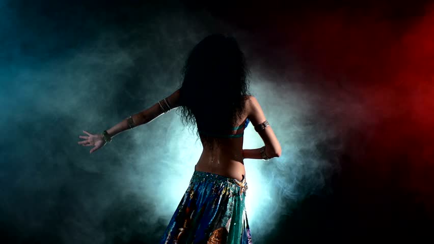 Torso of a beautiful, young girl female belly dancer on a black, smoke background, back light, cam moves down | Shutterstock HD Video #11332361