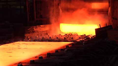 Rolled Sheets of Metal, Red Hot Metal, Worker in Orange Safety Helmet approached the rolled sheet, touched the sheet with tool, draw back, Donetsk Metallurgical Plant, Factory, pouring of liquid