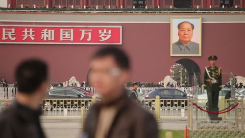 Tiananmen Square, Beijing - November 2010: A Chinese soldier stands guard in front of the portrait of Chairman Mao on the Tiananmen Gate in Beijing, China.