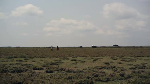 KENYA - CIRCA JULY 2013 - African people walk from mud house, Samburu, Kenya, Africa