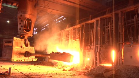 Worker is Passing By Machine is Loading The Coal Into The Blast Furnace Light from the Furnace Boiling Metal Melting Metal, Donetsk Metallurgical Plant, Pouring of Liquid Metal from Ore, Metal