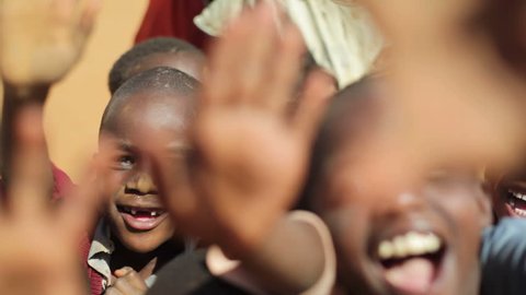 KENYA - CIRCA JULY 2013 - Children wave hello in Samburu, Kenya, Africa