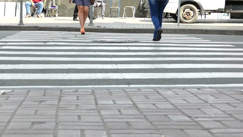 Crosswalk on  road Feet of woman in skirt.  Real shot at 100 FPS, ?? artifacts.

