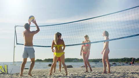 Group of Young People playing in Volleyball on the Beach. Shot on RED Cinema Camera in 4K (UHD).