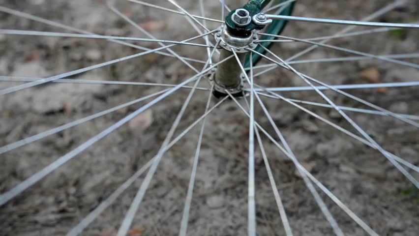 Large bicycle wheel spinning.