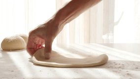 Wooden rolling pin on handmade dough on table 4K 3840X2160 30fps UHD footage - Rod type roller on hand kneaded dough 4K 2160p UltraHD video