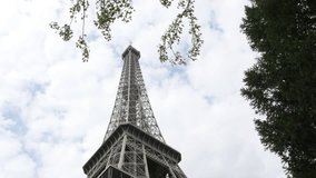 Tilt on Eiffel tower in Paris France by partialy cloudy weather 4K 3840X2160 UHD footage - French Eiffel tower construction in  front of cloudy blue sky 4K 2160p 30fps UltraHD video