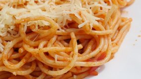 Tomato Italian cuisine pasta from durum wheat on the plate slow tilt 4K 2160p 30fps UltraHD video - Tasty spaghetti food from Italy made from wheat water and cheese tilting 4K 3840X2160 UHD footage