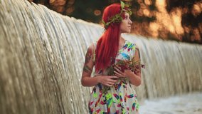 Bright girl with red hair. With a bouquet of berries and leaves on his head. The girl with a tattoo nature.  Bright modern summer makeup. Beauty, spa, manicure  and skincare concept