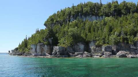 Passing the cliffs and trees of Flowerpot Island in Tobermory, Ontario, Canada.
