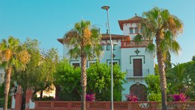 Beautiful Spanish house with palm trees, sunny summer day, 4k Salou City