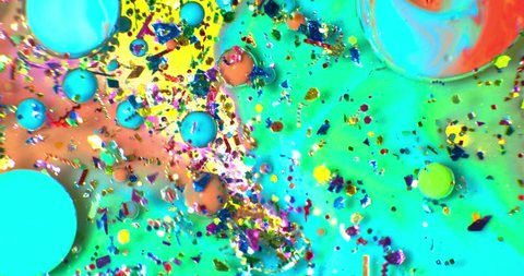 Color drops floating in oil and water over a colorful underground with oil painting effect. Shot on RED Arkistovideo