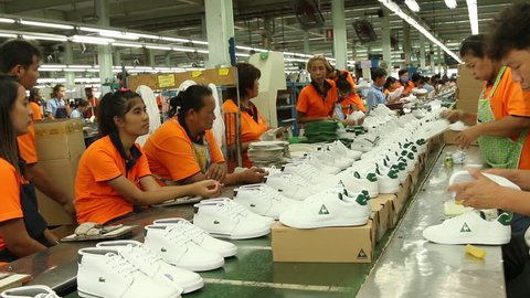 AYUTTHAYA PROVINCE,THAILAND, AUGUST 22 , 2015 : workers in footwear factory working on shoe in production-line,Thailand was a famous country where made a lot of footwear product for export business. 