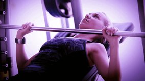 Attractive girl works with Barbell in modern gym