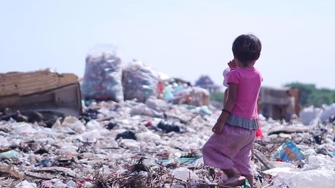 Myanmar, Yangon. 09.11.2013  Children at the dump. Dispossessed orphans. Hungry children looking for food in a landfill.