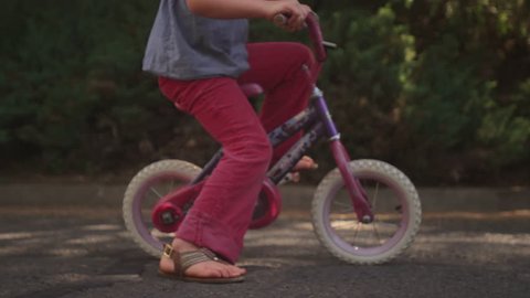 Close up of a girl riding a bicycle