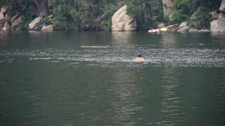 Aug 25,2014:People swimming in lake,relying on Castle Peak. gh2_02319