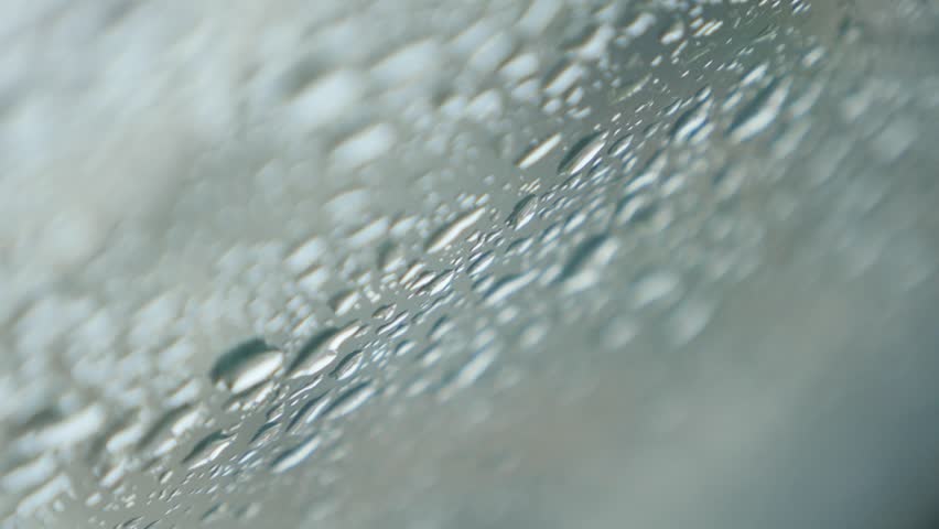 Tiny raindrops falling on car windshield glass shallow DOF 4K 2160p 30fps UltraHD footage - Windscreen under strong rain falling 4K 3840X2160 UHD video