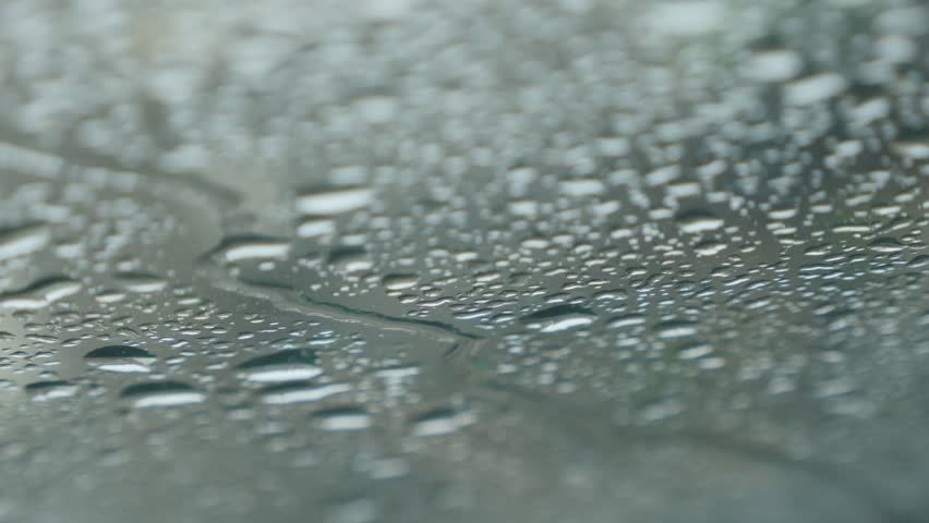Raindrops falling on car windshield glass shallow DOF 4K 2160p 30fps UltraHD footage - Windscreen under strong rain falling 4K 3840X2160 UHD video
