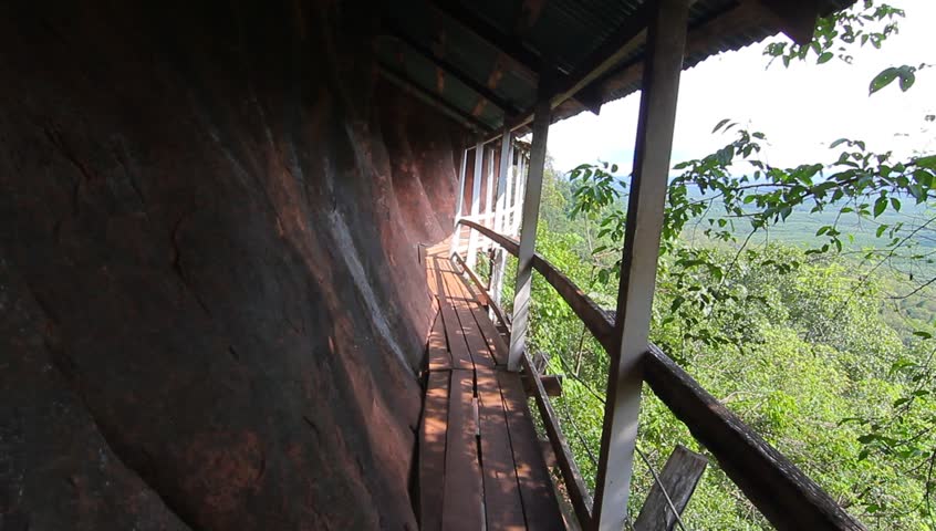 Phu Thok, travel in Thailand. Wooden ladder on the side of the rocky mountains.
