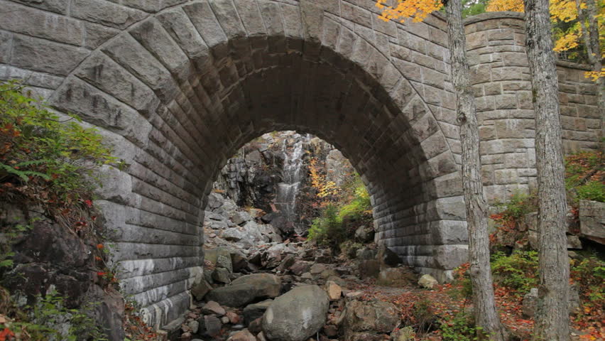 Locked down view of Waterfall Bridge and waterfall in Acadia National Park, Maine, in Autumn; includes ambient audio.