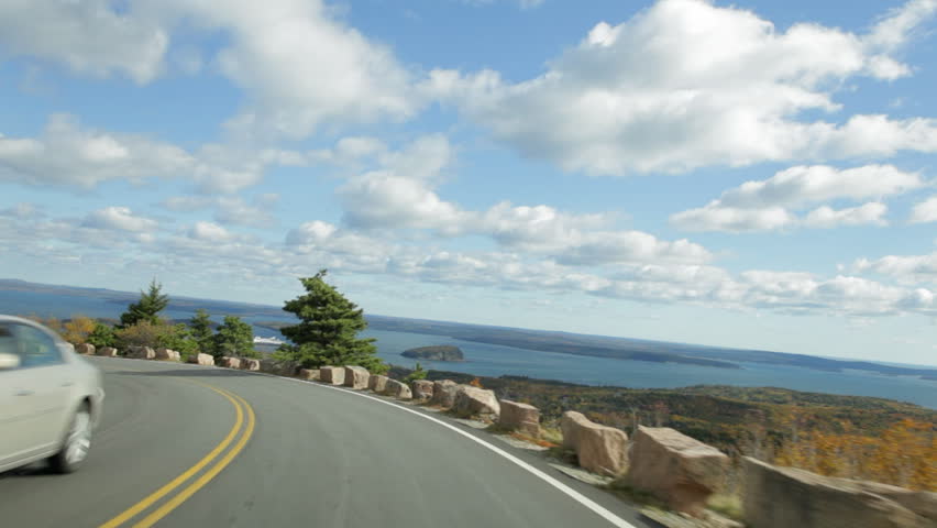 Driving POV on Cadillac Summit Road (part of the Park Loop Road) in autumn in Acadia National Park, Maine, USA.