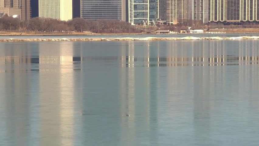 Chicago, Illinois skyline reflecting on Lake Michigan icy water