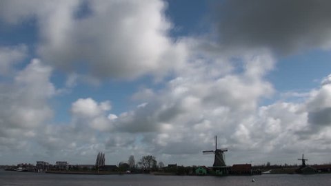 Dutch clouds are racing over scenic windmill landscape time lapse
