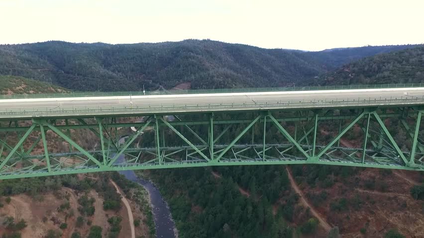 A beautiful arial view of a bridge, urban bridge spanning a river.