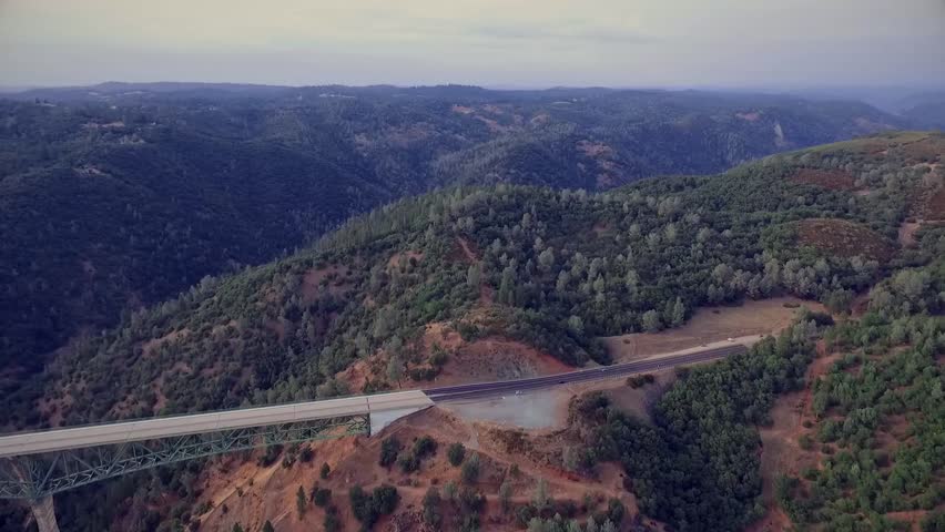 A beautiful arial view of a bridge, urban bridge spanning a river.