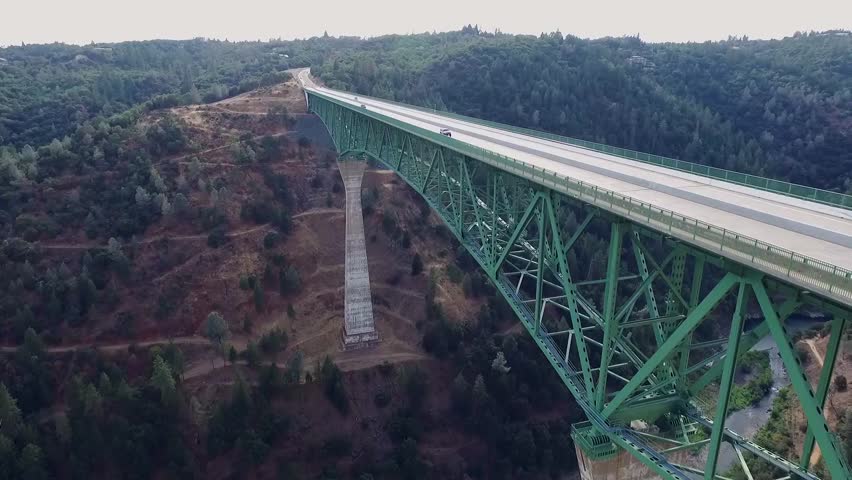 A beautiful arial view of a bridge, urban bridge spanning a river.