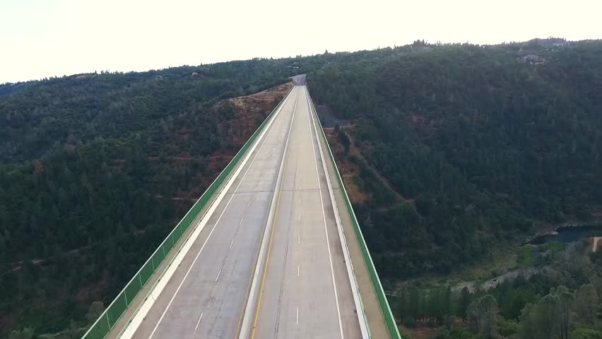 A beautiful arial view of a bridge, urban bridge spanning a river.