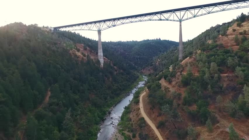A beautiful arial view of a bridge, urban bridge spanning a river.