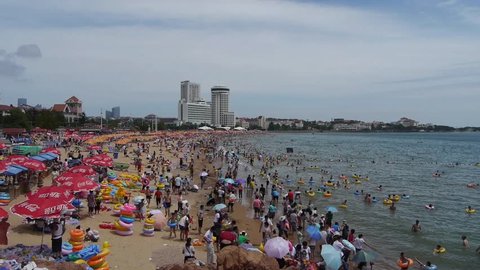 Oct 20,2014:A lot of people at crowded bathing sandy beach.People swim in sea,China's Qingdao City.timelapse. gh2_03125