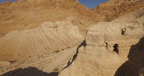 Soaring 4K aerial view above the Dead Sea Scroll caves in QUMRAN, ISRAEL. Filmed with permission.