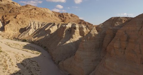 Soaring 4K aerial view above the Dead Sea Scroll caves in QUMRAN, ISRAEL. Filmed with permission.