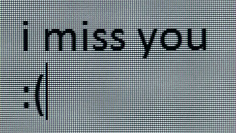 " i miss you :( " being typed on computer screen in close up so that individual pixels can be seen.