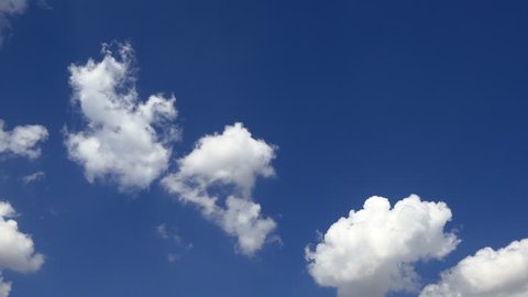 Clouds running across the blue sky. 1 Minute, 30 fps footage of 4K timelapse cloudscape. Cumulus clouds form against a brilliant blue sky. 4k Timelapse of white clouds with blue sky in background
