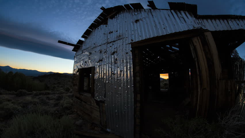 Sunrise Over Abandoned Barn Mine House with bullet holes 