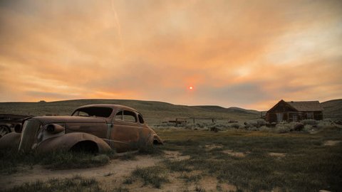 Hazy Sunrise Timelapse Over Abandoned Desert Town and Car 
