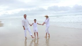 Family walking on a sandy beach