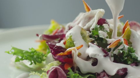 Cook Garnishing Vegetable Salad with Sour Cream. Shot on RED Cinema Camera in 4K (UHD).