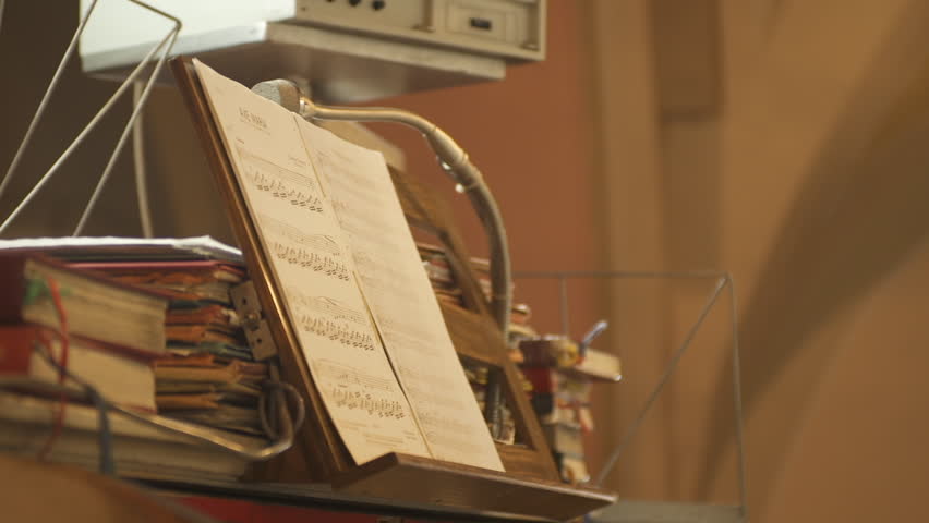 Young Blond Woman With Red Glasses Reads Ave Maria Note Sheet And Playing Organ