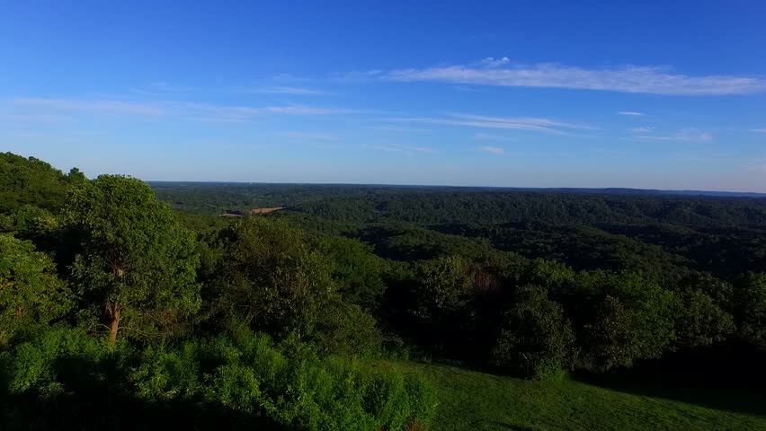 Epic flight over a  wooded landscape