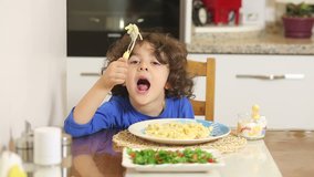 Little boy eating pasta. children eating appetite.